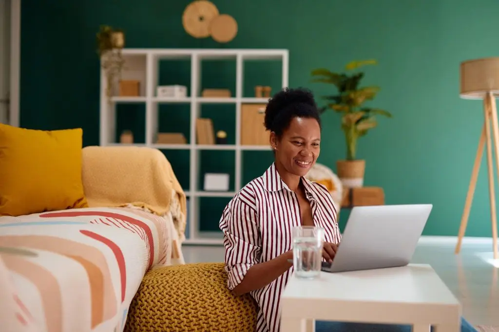 Woman working from home on a laptop representing AI side hustles and modern remote income opportunities