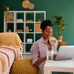 Woman working from home on a laptop representing AI side hustles and modern remote income opportunities