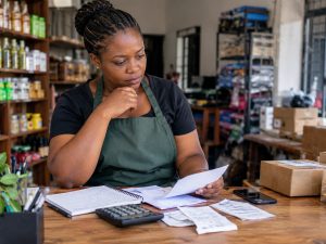 Small business owner reviewing records and daily operations